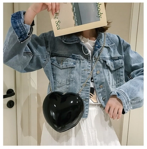 Glossy black heart-shaped lacquer crossbody bag with elegant gold metal chain strap