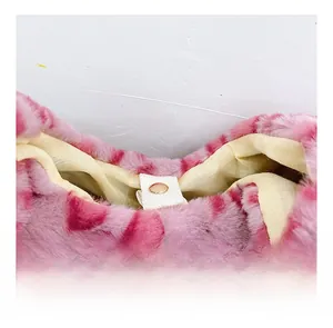 Close-up of pink leopard plush fabric and golden metal snap fastener detail