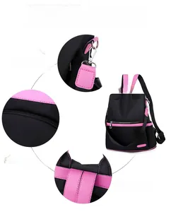 Detail of durable fabric and metal rings on a black and pink anti-theft women's backpack
