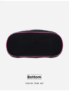 Detail view of the wide black nylon bag bottom with stylish pink piping and durable base