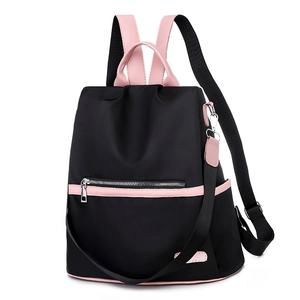 Detail view of the black and pink contrast backpack with water-resistant nylon texture