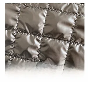 Close-up of high-gloss black quilted fabric with classic diamond stitch details