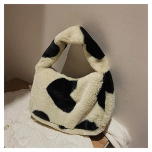 Gros plan du sac à main en peluche à motif vache avec texture douce et forme lune
