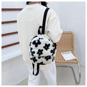 Détail de la texture en fausse fourrure douce et des motifs floraux sur ce sac à dos peluche