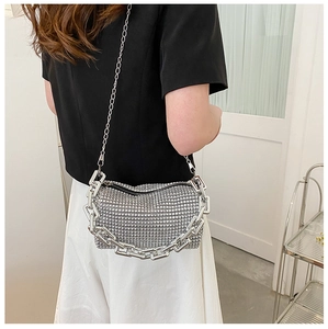 Detail of silver rhinestone evening bag featuring chunky chain and sparkling sequins