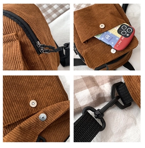 Detail der braunen Cordtasche mit Metallmagnetverschluss, Doppelreißverschluss und Handyfach