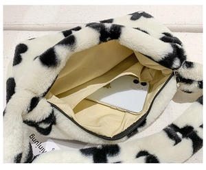 Détail intérieur du sac en peluche à motif cœurs montrant doublure et poches internes