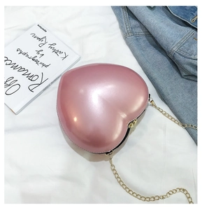 Detailed top view of pink heart-shaped mini chain bag with metallic pearl finish