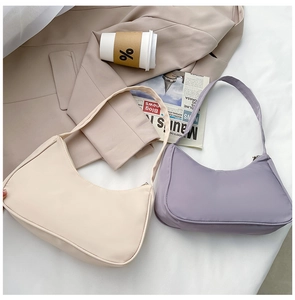 Flat lay of beige and light purple nylon crescent shoulder bags with a coffee cup