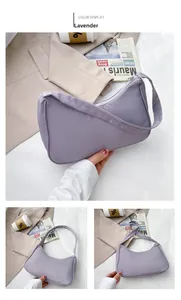 Macro shot of lightweight light purple nylon half-moon shoulder bag with zipper detail