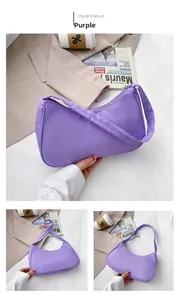 Detailed view of purple nylon hobo bag featuring smooth metal zipper and wide strap