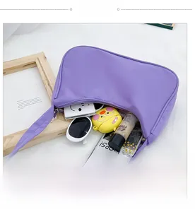 Spacious interior of a light purple nylon hobo bag showing daily essentials for women
