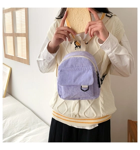 Detailaufnahme der lila Cord-Minirucksack-Textur und der cremefarbenen Träger