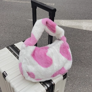 Sac seau en peluche pour femme à motif cœur rose et blanc sur une valise