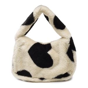 Sac seau en fausse fourrure avec imprimé vache noir et blanc et anse en peluche