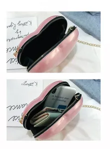 Internal view of pink heart-shaped bag with gold chain showing storage capacity