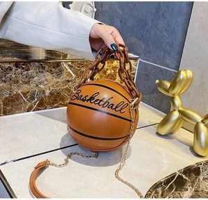 Detail shot of a trendy basketball shaped crossbody bag with acrylic chain handle