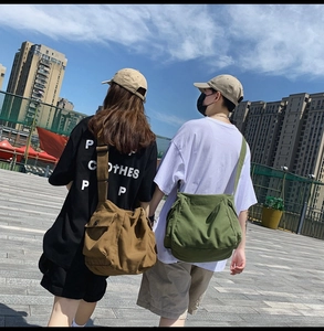 Outdoor shot of khaki and army green canvas crossbody bags with large side pockets