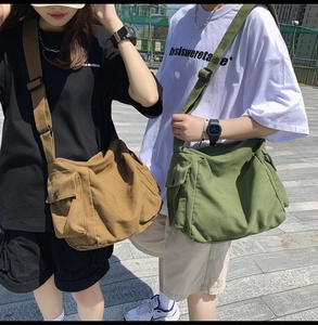 Detailed outdoor view of large canvas messenger bags in coffee brown and olive green