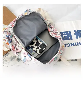 Detailed interior of butterfly print backpack showing large capacity for laptops