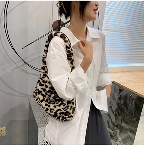 Detailed view of plush leopard print faux fur shoulder bag worn under the arm