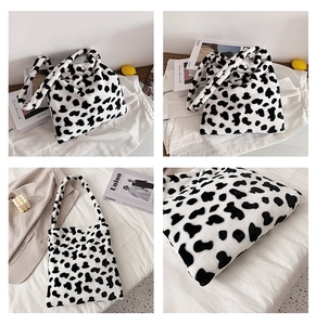 Detailed close-up of cow print plush tote bag showing soft faux fur texture and large size