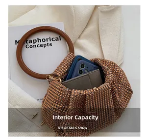 Detailed interior of the orange rhinestone handbag showing phone and card holder capacity