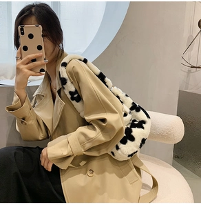 Fashionable plush cow print underarm bag shown styled with a modern outfit