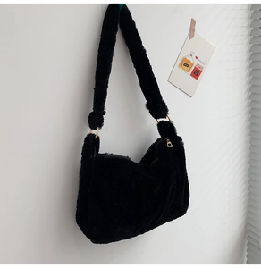 Detailansicht der schwarzen Kunstpelz-Schultertasche mit goldenen Metallteilen und Pelz