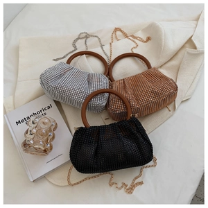 Detailed view of rhinestone pleated handbags in silver, gold, and black with round handles