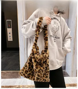 Detail of leopard print faux fur tote bag with wide soft shoulder strap for winter fashion