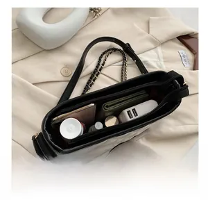 Macro shot of large interior storage capacity in quilted black and white leather shoulder bag