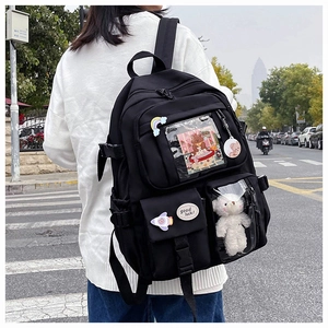 Detail of black multi-pocket backpack with transparent window and plush pendant