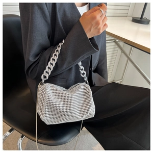 Detail of silver rhinestone shoulder bag with metal chain strap and luxury finish