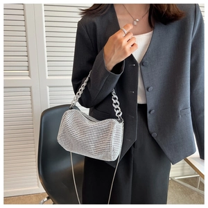 Detail of silver rhinestone shoulder bag with chunky handle chain and slim metal strap