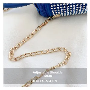 Detail shot showing the adjustable gold chain strap and sparkling blue rhinestone bag surface