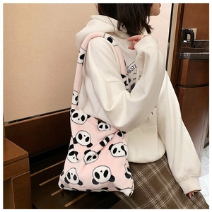 Pink plush tote bag with panda prints shown on model for size and soft texture reference