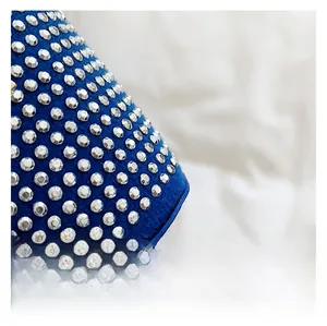 Close-up of premium dark blue fabric with glittering silver rhinestone detailing