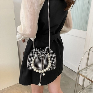 Elegant black bucket bag with sparkling rhinestones, pearl handle, and metal chain strap