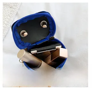 Internal view of blue sequin mini bag showing space for lipstick and makeup compact