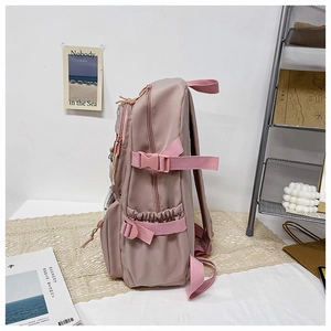 Detail view of pink Japanese style backpack with side adjustable buckles and zippers