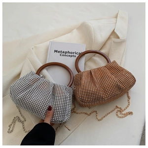 Close-up of sparkling rhinestone evening bags with resin handles and chain straps