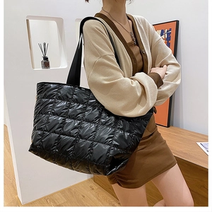 Close-up of black quilted puffer tote bag with durable nylon texture and large capacity