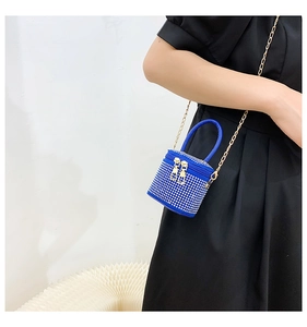 Detailed close-up of a royal blue mini rhinestone cylinder bag with gold chain strap