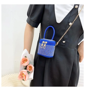 Detail of royal blue rhinestone mini handbag featuring gold chain and sparkling crystals