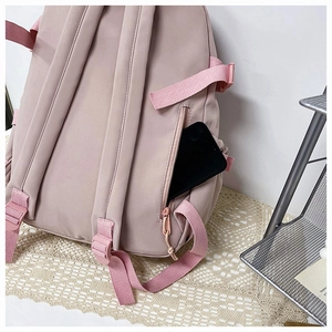 Detail of hidden anti-theft back zipper pocket on pink nylon backpack for smartphone
