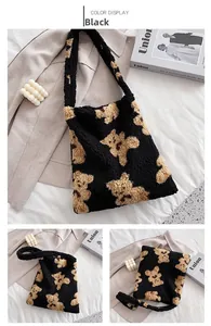 Close-up of black fuzzy tote bag featuring brown teddy bear pattern and plush texture