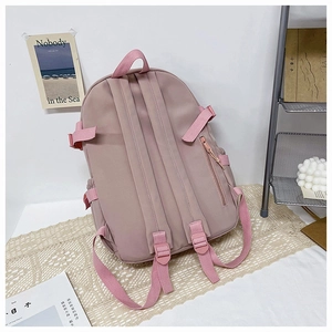 Rear view of pink backpack featuring S-shaped padded straps and hidden anti-theft pocket