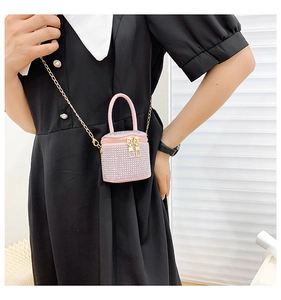 Detail of pink mini rhinestone bucket bag with gold chain strap and crystal finish
