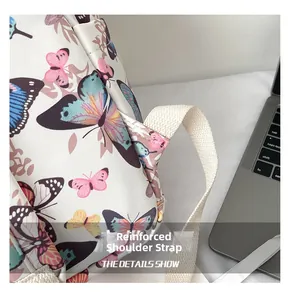 Close-up of reinforced shoulder strap stitching on butterfly print student backpack